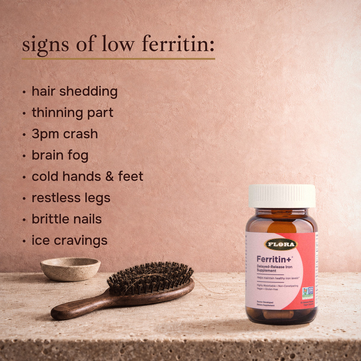 The 8 signs of low ferritin: hair shedding, thinning part, 3pm crash, brain fog, cold hands and feet, restless legs, brittle nails, ice cravings, with a hairbrush and the Ferritin+ bottle